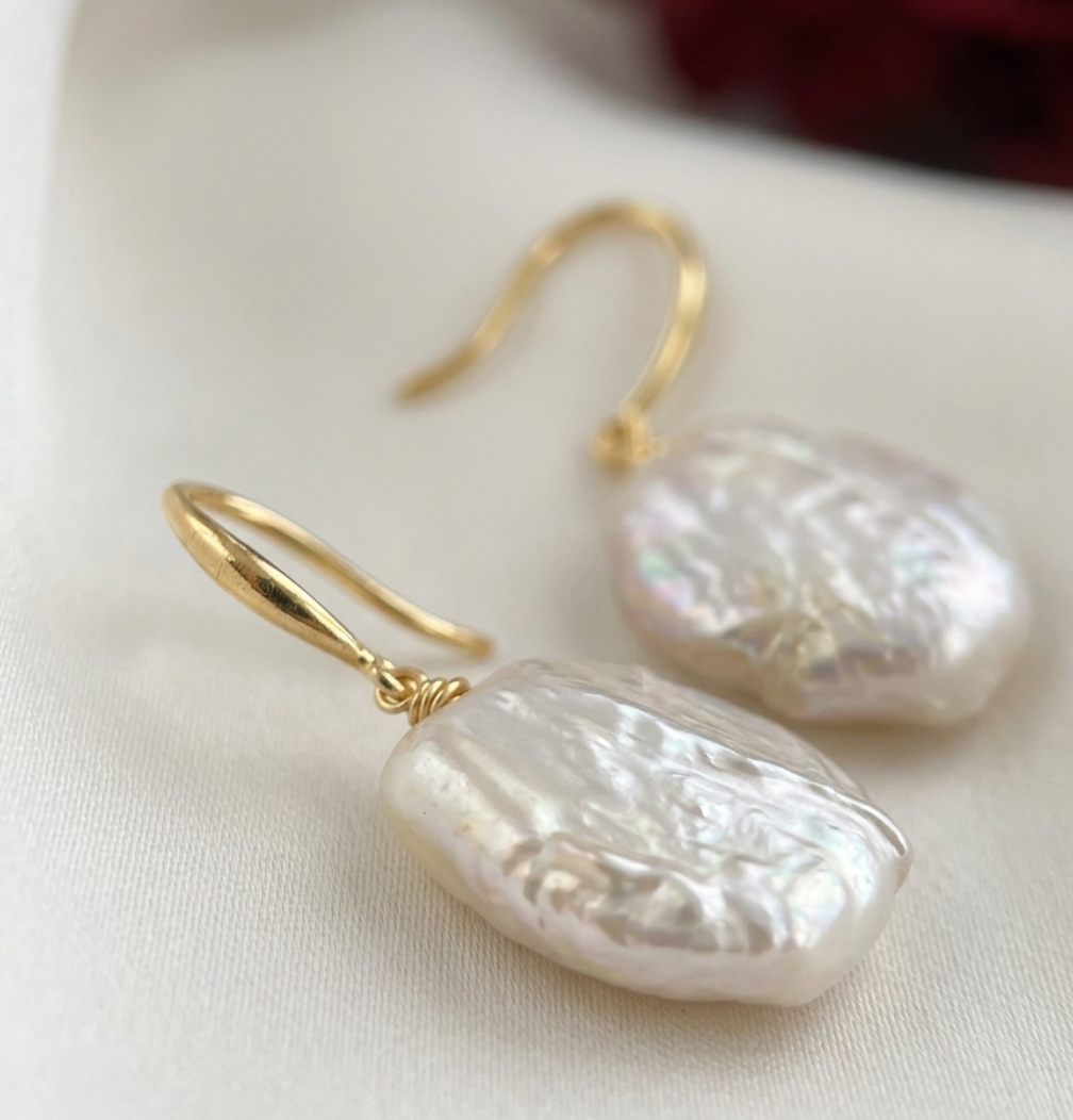 closeup of irregular shaped pearl earrings