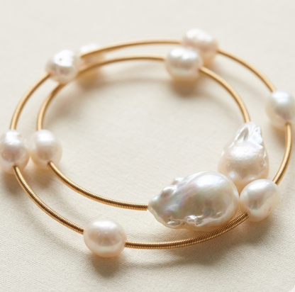 Gold bracelet with pearls on a light beige background