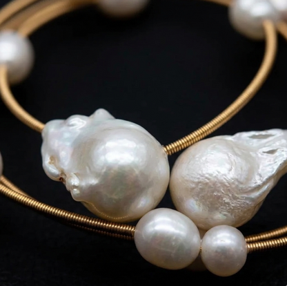 Gold bracelet with pearls on a black background