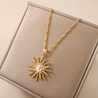 Gold necklace with sun pendant on a beige box