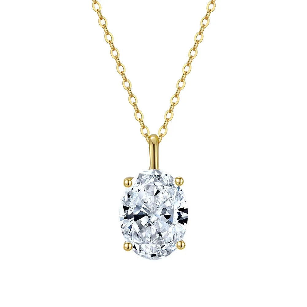 Gold necklace with a oval shaped cubic zirconia pendant on a white background