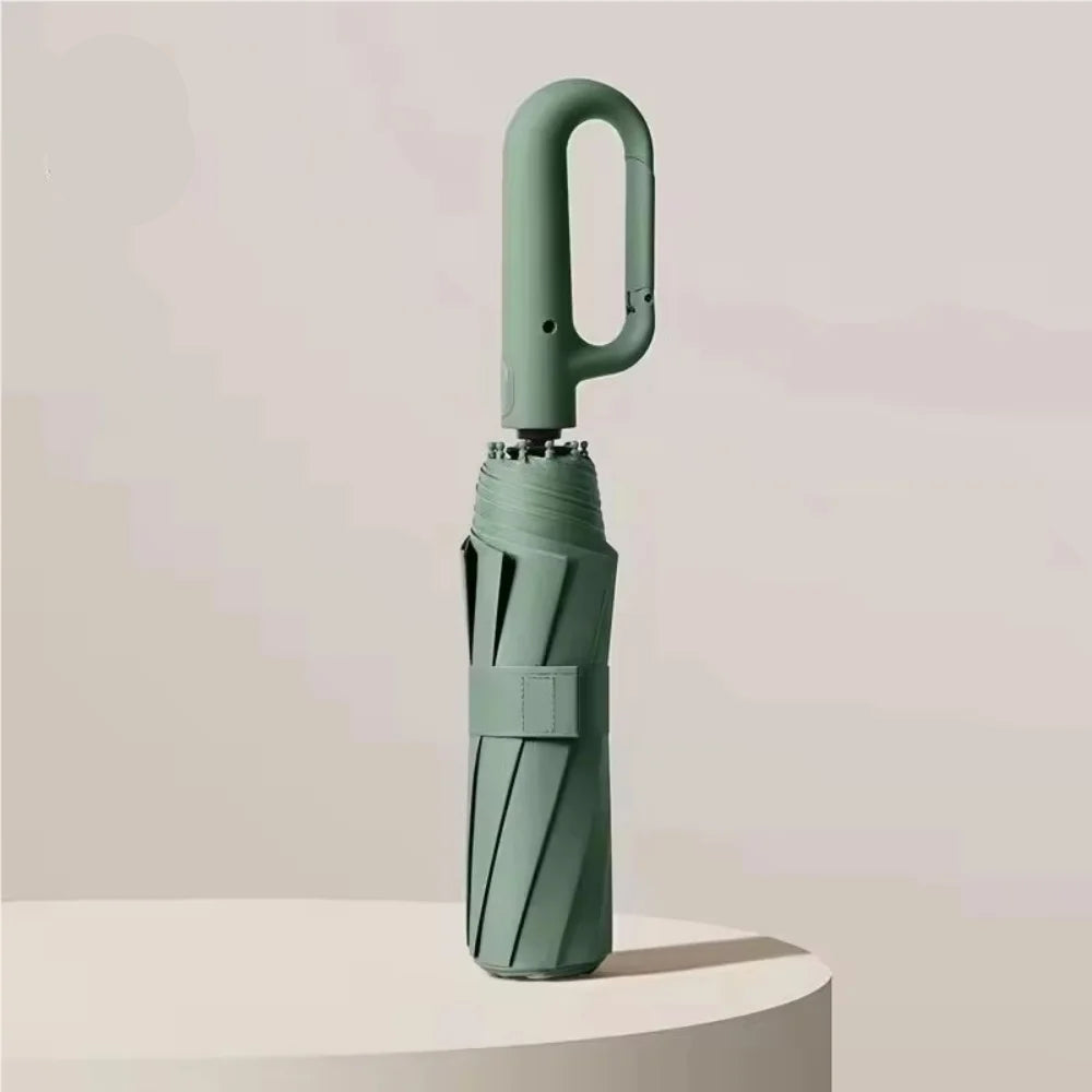Green umbrella with UPF50+ label on a light background