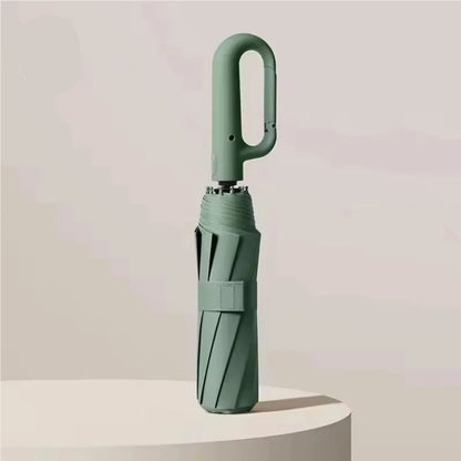 Green umbrella with UPF50+ label on a light background