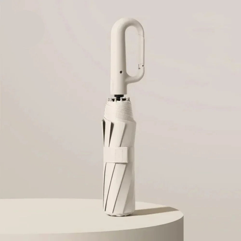 White umbrella with UPF50+ label on a light gray background